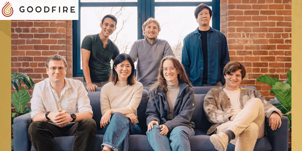 The Goodfire team posed on a sofa in front of a brick wall, with the Goodfire logo